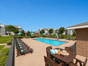 Resort style swimming pool with lounge chairs 1